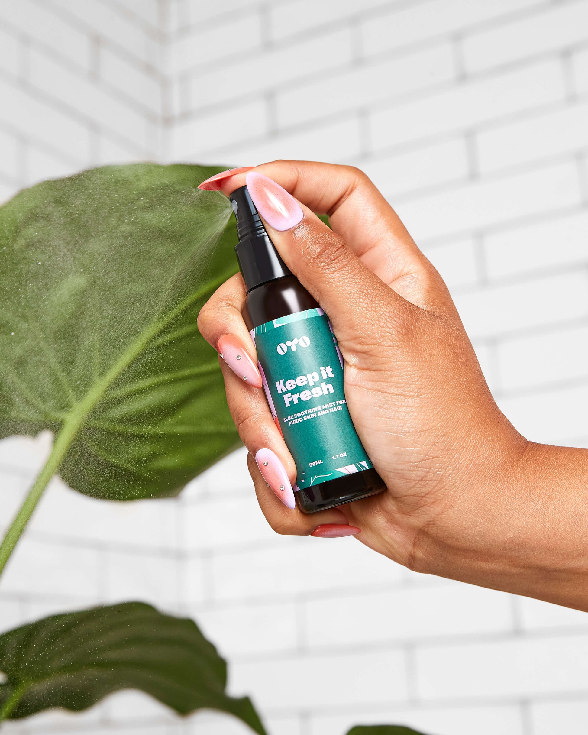 Hand holding Keep It Fresh spray for irritation-free hair removal and soothing sensitive skin.